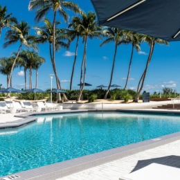 Resort-style swimming pool with lounge seating