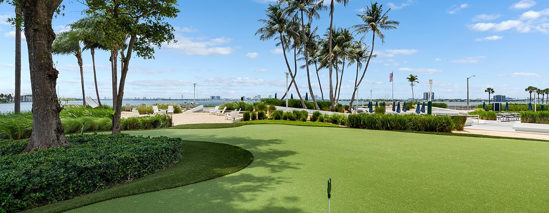 a golf course with trees and bushes